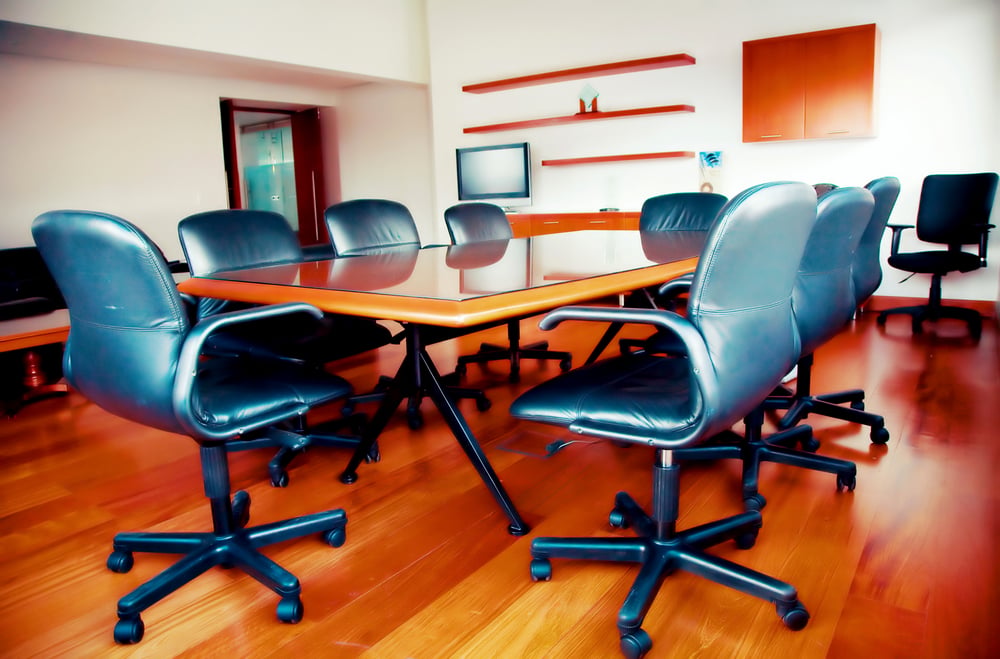 modern office meeting room with leather chairs and wodden floors